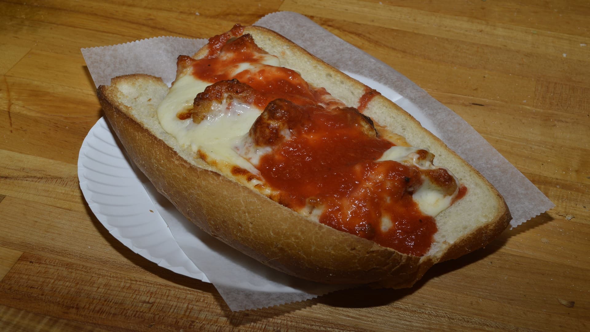 Hot and delicious meatball parmigiana hero smothered with mozzarella cheese